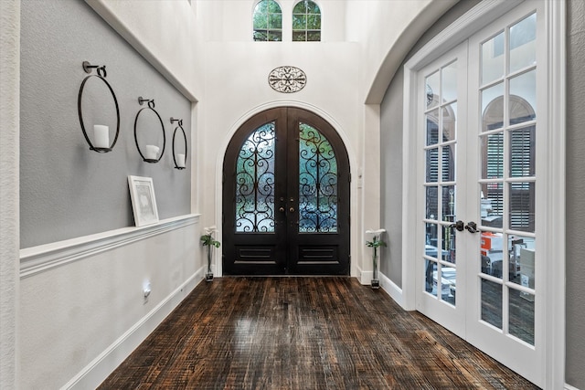 6500 Lazy Oak Ln, Plano, TX 75024 - foyer featuring french doors, arched walkways, wood finished floors, baseboards, and a towering ceiling