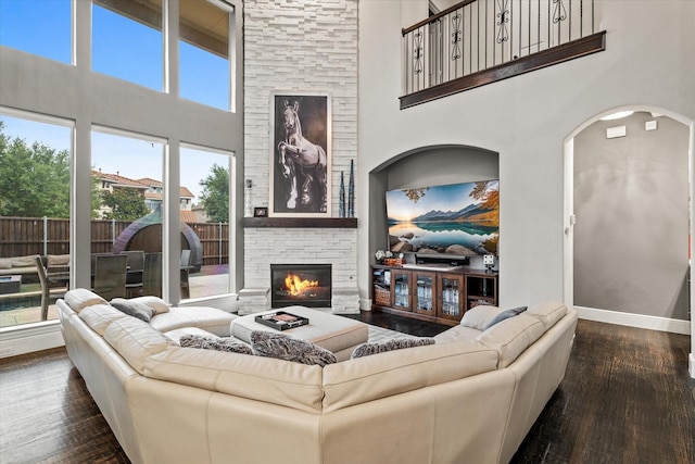 6500 Lazy Oak Ln, Plano, TX 75024 - living room featuring a towering ceiling, hardwood / wood-style flooring, baseboards, and a fireplace