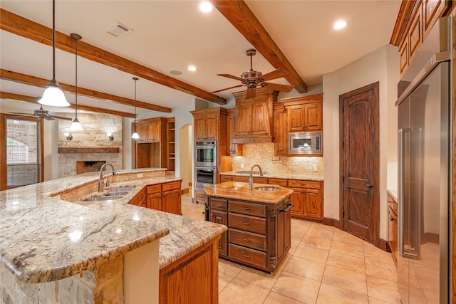 2454 Savanna Cir, Midlothian, TX 76065 - kitchen featuring a sink, ceiling fan, a large island with sink, appliances with stainless steel finishes, and recessed lighting
