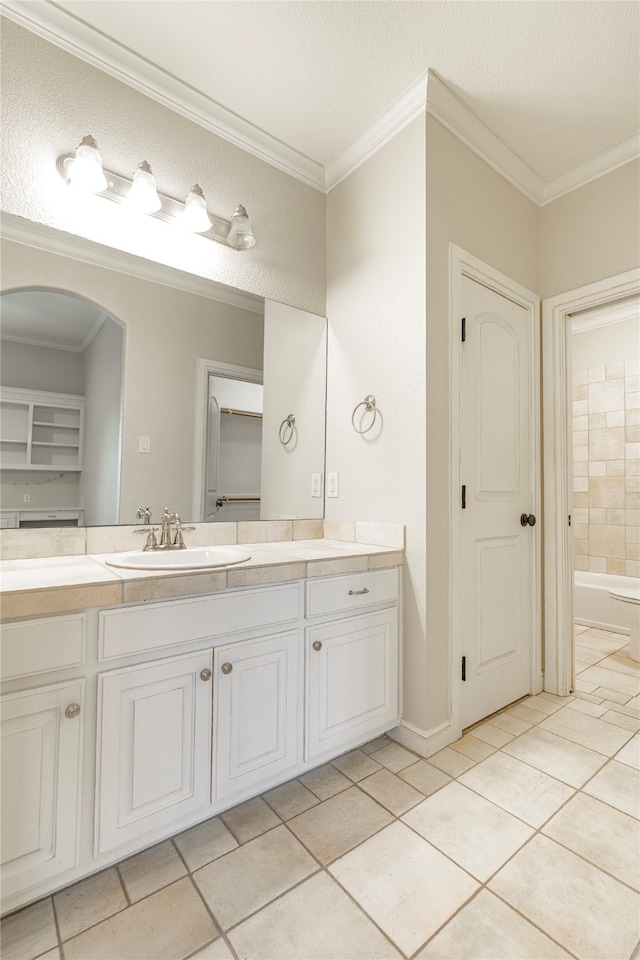 2454 Savanna Cir, Midlothian, TX 76065 - full bathroom featuring vanity, ornamental molding, tile patterned flooring, and a bathtub