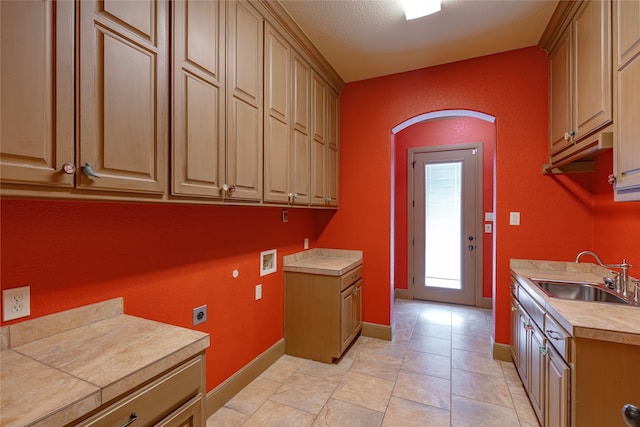 2454 Savanna Cir, Midlothian, TX 76065 - laundry area with cabinet space, baseboards, arched walkways, and hookup for an electric dryer