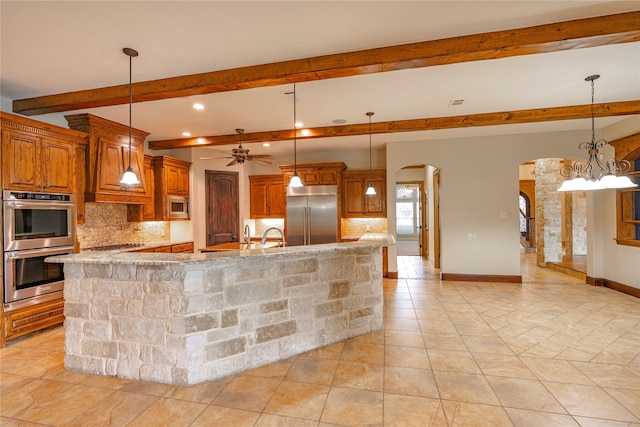 2454 Savanna Cir, Midlothian, TX 76065 - kitchen with built in appliances, arched walkways, tasteful backsplash, beamed ceiling, and brown cabinets