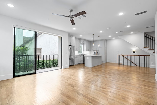 4133 Emerson Ave Unit 1, University Park, TX 75205 - unfurnished living room featuring baseboards, light wood-style floors, ceiling fan, recessed lighting, and stairway