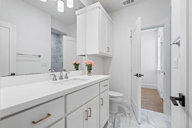 4133 Emerson Ave Unit 1, University Park, TX 75205 - full bathroom featuring vanity, toilet, marble finish flooring, baseboards, and a shower