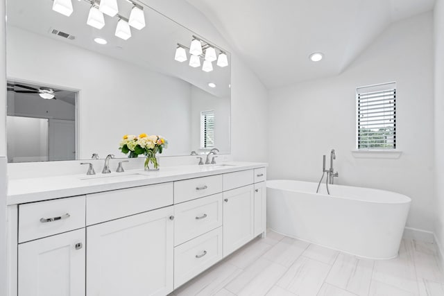 4133 Emerson Ave Unit 1, University Park, TX 75205 - bathroom with vaulted ceiling, double vanity, a soaking tub, recessed lighting, and marble finish floors