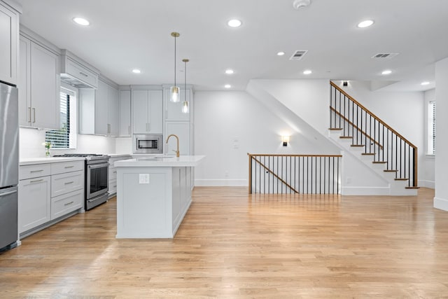 4133 Emerson Ave Unit 1, University Park, TX 75205 - kitchen featuring stainless steel appliances, light countertops, light wood finished floors, baseboards, and recessed lighting