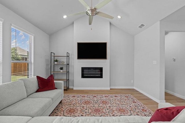 10650 Barrington Ln, Fort Worth, TX 76126 - living area with light wood finished floors, lofted ceiling, a ceiling fan, a glass covered fireplace, and recessed lighting