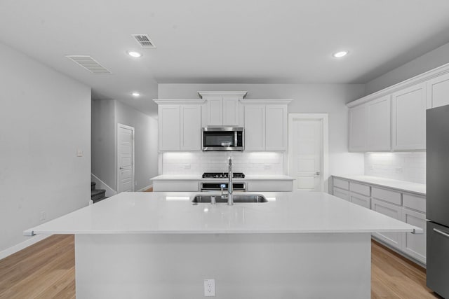 10650 Barrington Ln, Fort Worth, TX 76126 - kitchen with stainless steel appliances, a center island with sink, decorative backsplash, light countertops, and recessed lighting