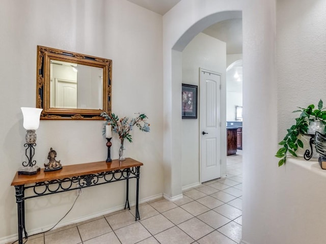 1071 Shepard Ln, Lavon, TX 75166 - corridor with arched walkways, light tile patterned flooring, and baseboards