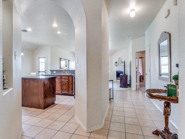1071 Shepard Ln, Lavon, TX 75166 - bar with light tile patterned floors, plenty of natural light, lofted ceiling, arched walkways, and a fireplace