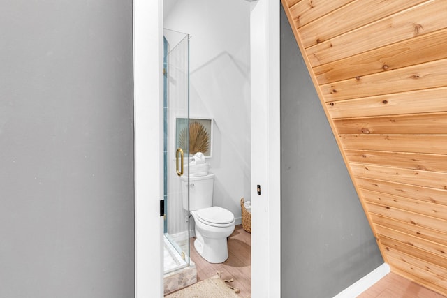1223 Whispering Springs Dr, Tool, TX 75143 - bathroom with toilet, a stall shower, wood finished floors, and baseboards