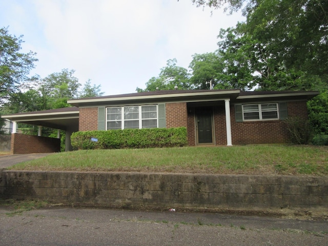 611 W 4th St, Homer, LA 71040 - ranch-style house featuring brick siding, an attached carport, driveway, and a front lawn