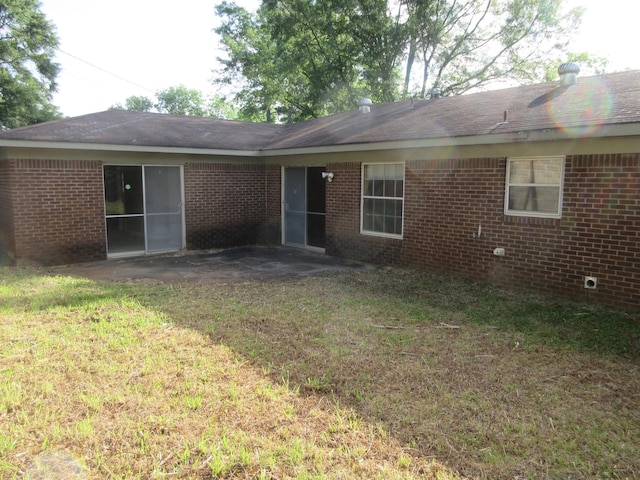 611 W 4th St, Homer, LA 71040 - back of property featuring a yard, brick siding, and a patio area