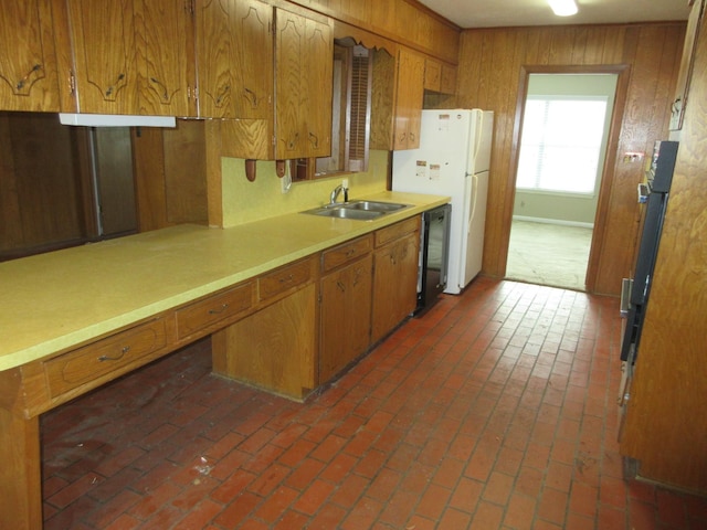 611 W 4th St, Homer, LA 71040 - kitchen featuring a sink, wood walls, brown cabinets, freestanding refrigerator, and light countertops