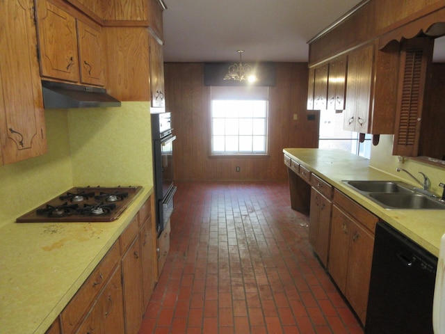611 W 4th St, Homer, LA 71040 - kitchen with a sink, black appliances, under cabinet range hood, light countertops, and brick floors