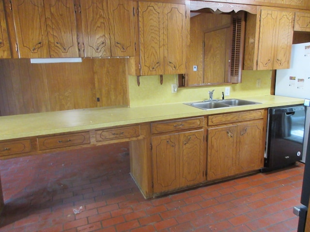 611 W 4th St, Homer, LA 71040 - kitchen with a sink, dishwasher, light countertops, brown cabinetry, and brick floors