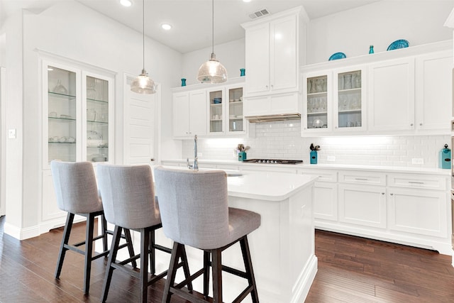 3912 River Bend St, Mckinney, TX 75071 - kitchen with a kitchen bar, light countertops, white cabinets, tasteful backsplash, and recessed lighting