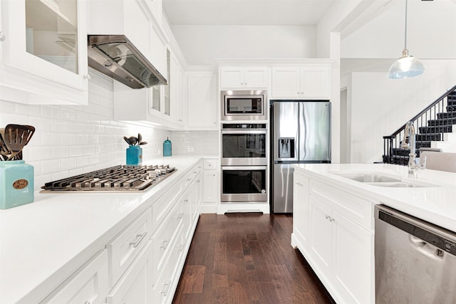 3912 River Bend St, Mckinney, TX 75071 - kitchen featuring stainless steel appliances, custom exhaust hood, light countertops, white cabinetry, and glass insert cabinets