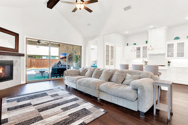 3912 River Bend St, Mckinney, TX 75071 - living area featuring ceiling fan, beam ceiling, dark wood finished floors, a premium fireplace, and high vaulted ceiling