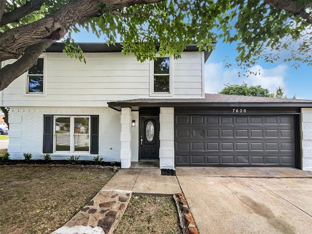 7620 Clover Ln, Watauga, TX 76148 - traditional home with driveway, brick siding, and a garage