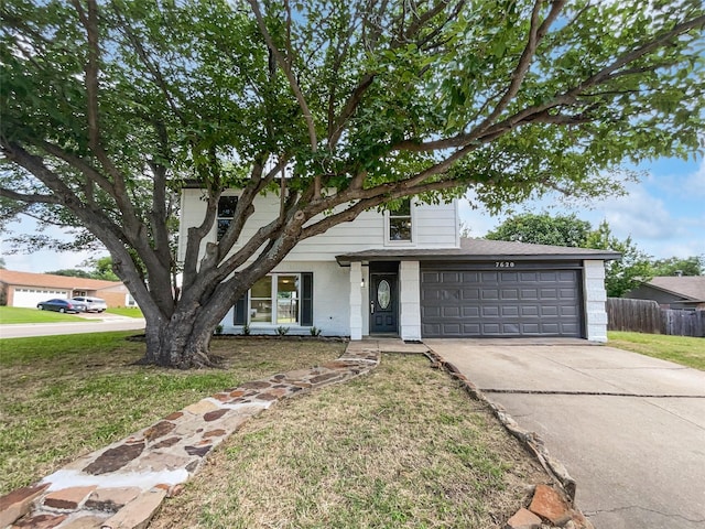 7620 Clover Ln, Watauga, TX 76148 - view of front of home featuring concrete driveway, an attached garage, and brick siding