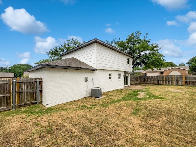 7620 Clover Ln, Watauga, TX 76148 - back of house with brick siding, a shingled roof, and central air condition unit