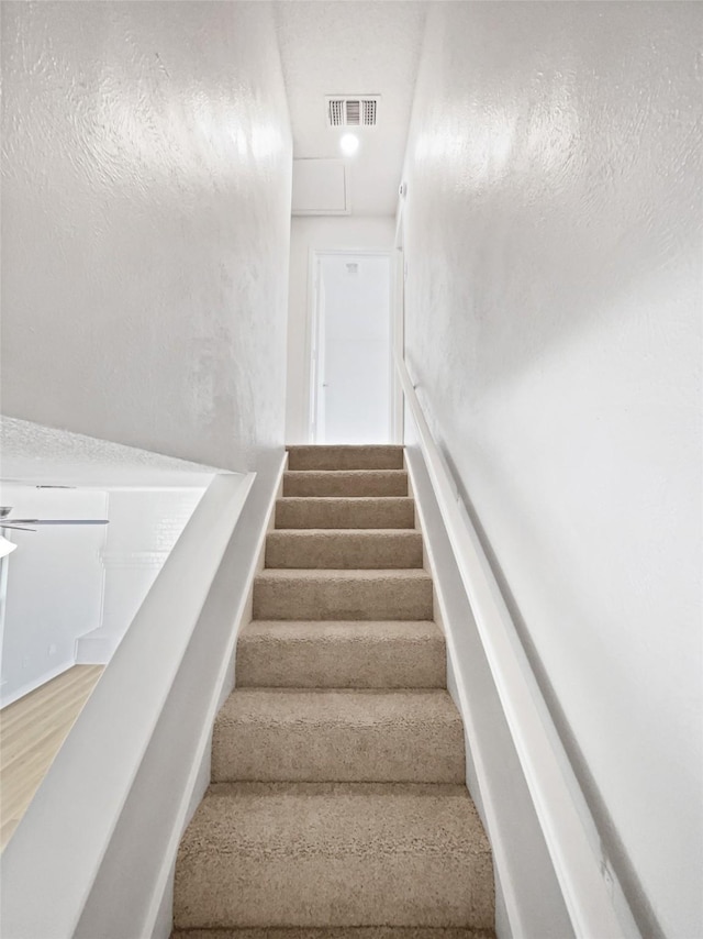 7620 Clover Ln, Watauga, TX 76148 - stairway featuring wood finished floors