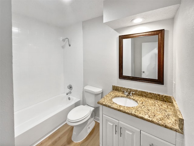 7620 Clover Ln, Watauga, TX 76148 - bathroom featuring wood finished floors, toilet, vanity, bathing tub / shower combination, and baseboards