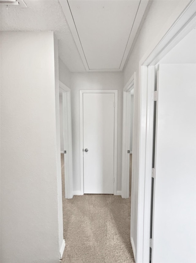 7620 Clover Ln, Watauga, TX 76148 - hallway with attic access, carpet flooring, and baseboards