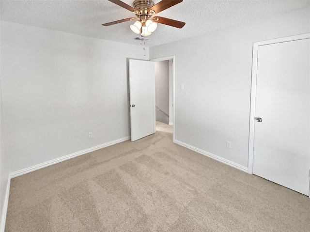 7620 Clover Ln, Watauga, TX 76148 - unfurnished bedroom with carpet flooring, a textured ceiling, baseboards, and ceiling fan