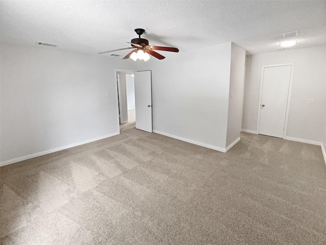 7620 Clover Ln, Watauga, TX 76148 - carpeted spare room with a ceiling fan, a textured ceiling, and baseboards
