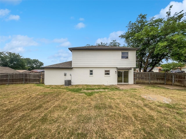 7620 Clover Ln, Watauga, TX 76148 - rear view of house featuring brick siding, a patio area, central AC, and roof with shingles