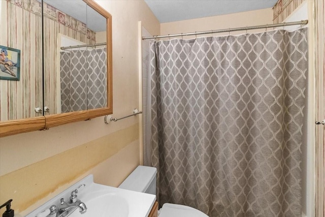 2311 Anderson St, Irving, TX 75062 - bathroom with toilet, vanity, and a shower with curtain