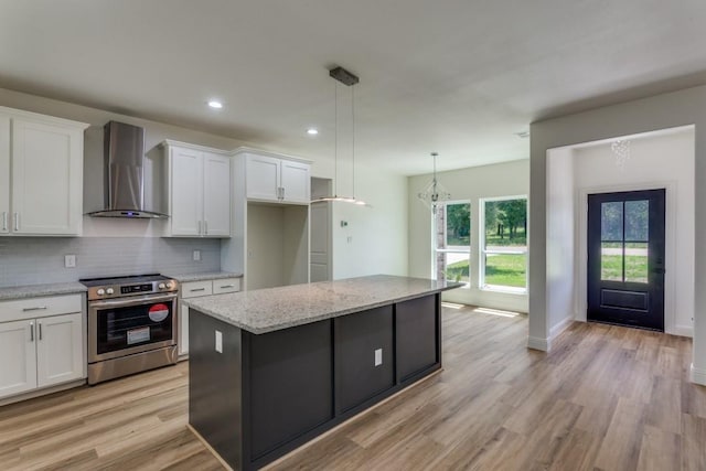 103 Jim Walters Dr, Runaway Bay, TX 76426 - kitchen featuring electric stove, wall chimney exhaust hood, white cabinetry, and recessed lighting