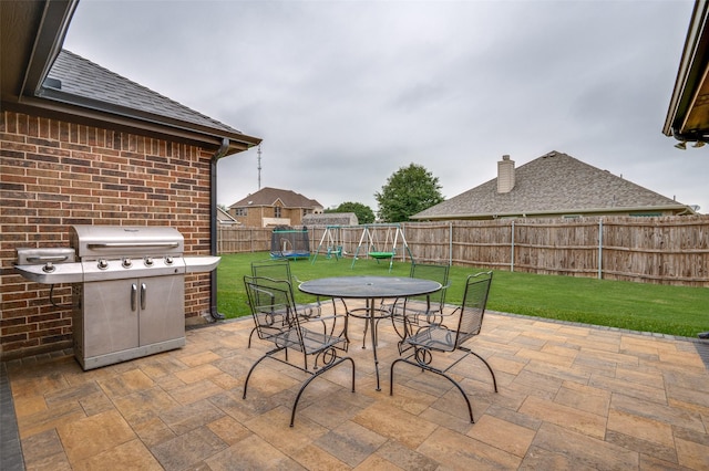 101 Aucuba Ln, Waxahachie, TX 75165 - view of patio with a grill, outdoor dining space, and a playground