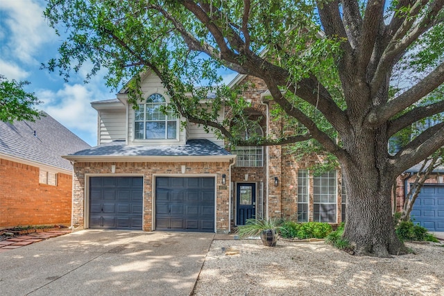 4037 Azure Ln, Addison, TX 75001 - view of front facade featuring a garage, driveway, and brick siding