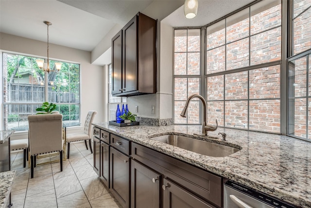4037 Azure Ln, Addison, TX 75001 - kitchen with a sink, stainless steel dishwasher, a chandelier, dark brown cabinetry, and light stone counters