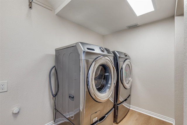 4037 Azure Ln, Addison, TX 75001 - laundry area with washing machine and clothes dryer, wood finished floors, and baseboards