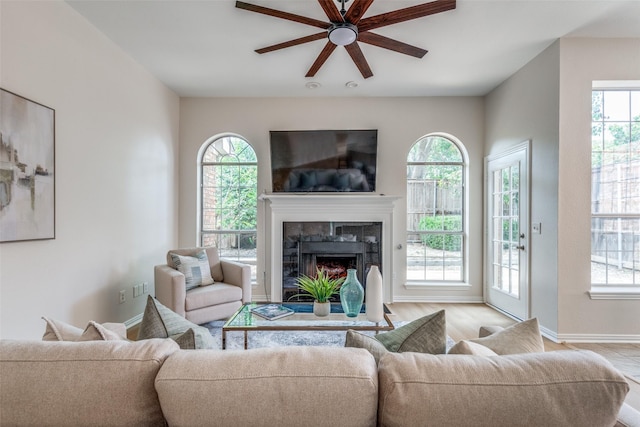 4037 Azure Ln, Addison, TX 75001 - living room with ceiling fan, a tile fireplace, healthy amount of natural light, and baseboards
