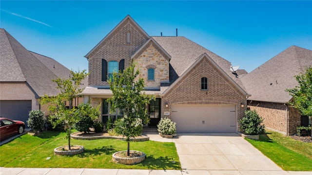 1507 Calcot Ln, Forney, TX 75126 - french country inspired facade with brick siding, driveway, a front yard, a shingled roof, and stone siding