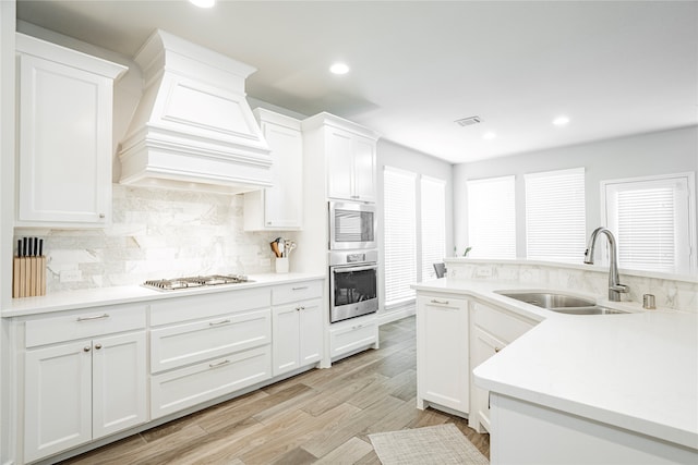 1507 Calcot Ln, Forney, TX 75126 - kitchen with a sink, wall chimney exhaust hood, gas stovetop, white cabinets, and recessed lighting