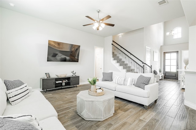 1507 Calcot Ln, Forney, TX 75126 - living area featuring light wood-style flooring, a ceiling fan, stairs, and baseboards