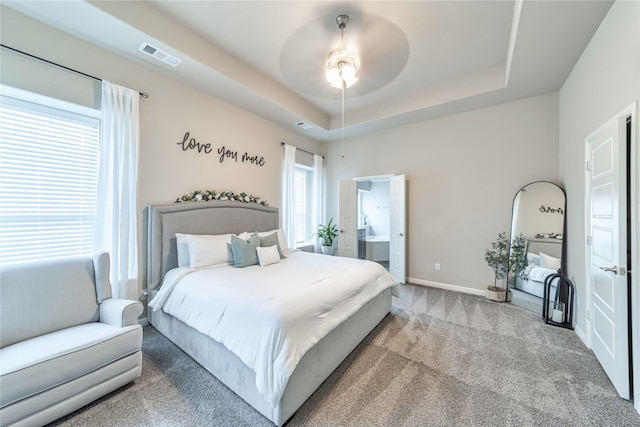293 Cisco Trl, Forney, TX 75126 - carpeted bedroom featuring a raised ceiling, baseboards, ceiling fan, and connected bathroom