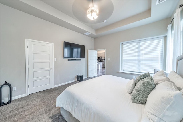 293 Cisco Trl, Forney, TX 75126 - carpeted bedroom featuring baseboards, a tray ceiling, and a ceiling fan