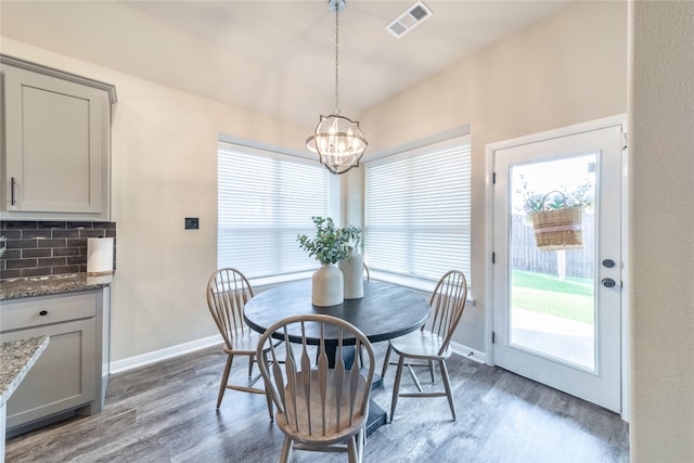 293 Cisco Trl, Forney, TX 75126 - dining area featuring a chandelier, wood finished floors, baseboards, and vaulted ceiling