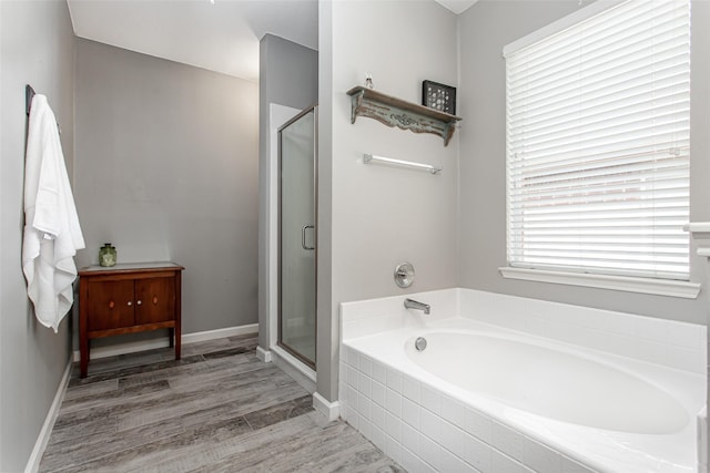 1253 Stone Ln, Celina, TX 75009 - bathroom with a bath, a stall shower, and wood finished floors