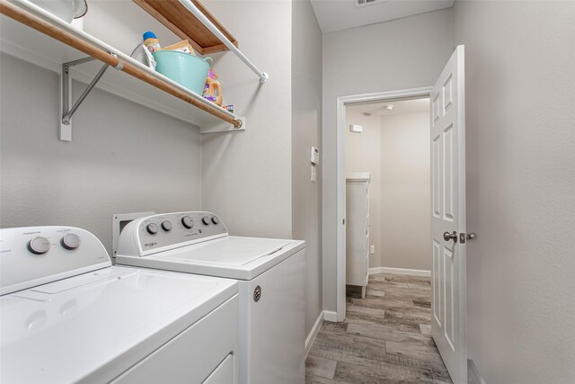 1253 Stone Ln, Celina, TX 75009 - washroom featuring washing machine and dryer, light wood-style floors, and baseboards