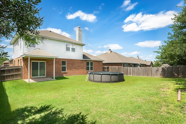 1253 Stone Ln, Celina, TX 75009 - back of property featuring brick siding and a chimney