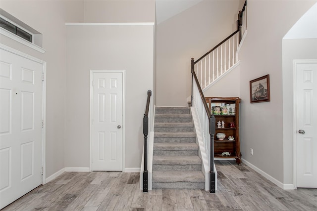 1253 Stone Ln, Celina, TX 75009 - staircase featuring wood finished floors, baseboards, and a high ceiling