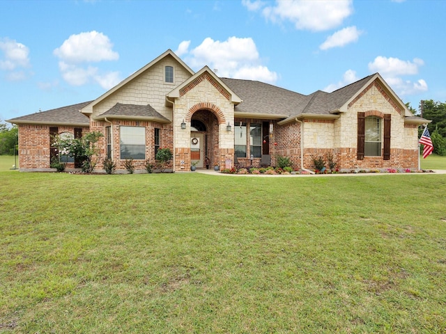 270 Pecan Hollow Cir, Anna, TX 75409 - view of front of home featuring a shingled roof, a front yard, and stone siding